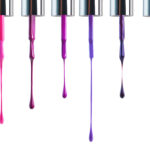 a row of paint samples dripping down a white background. Pinks and purples.